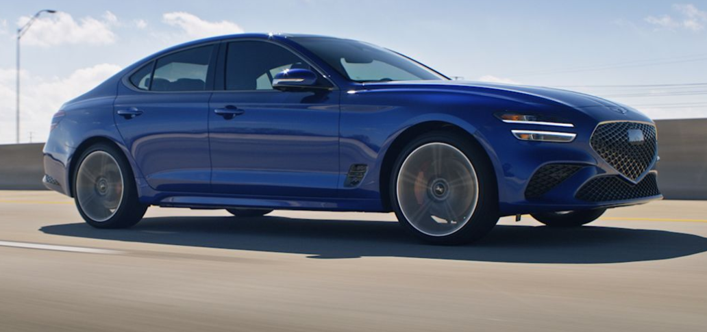 2025 Blue Genesis G70 driving down a Bay Area California highway.