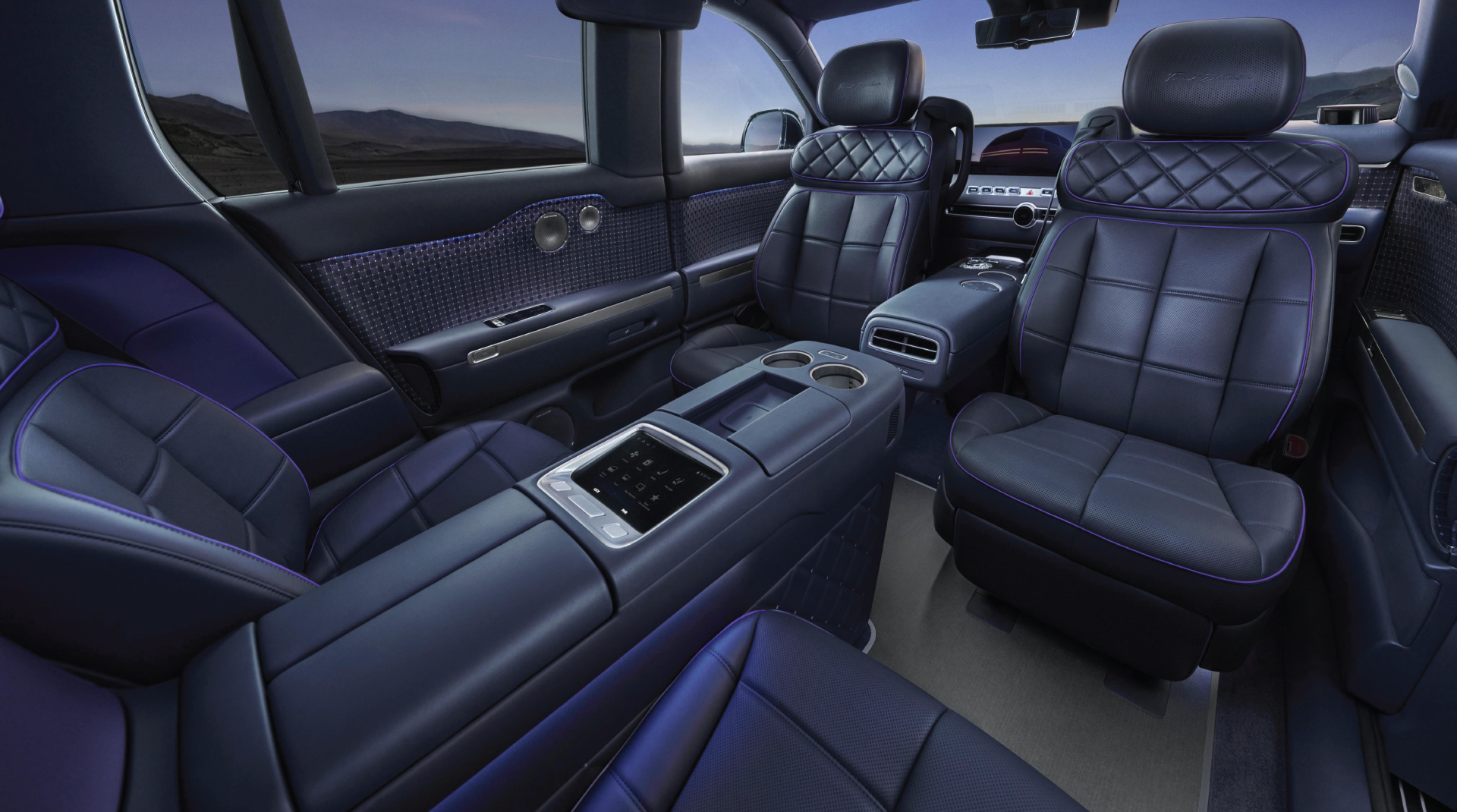 Luxurious car interior with dark quilted leather seats, purple accents, a large center console, and ambient lighting.